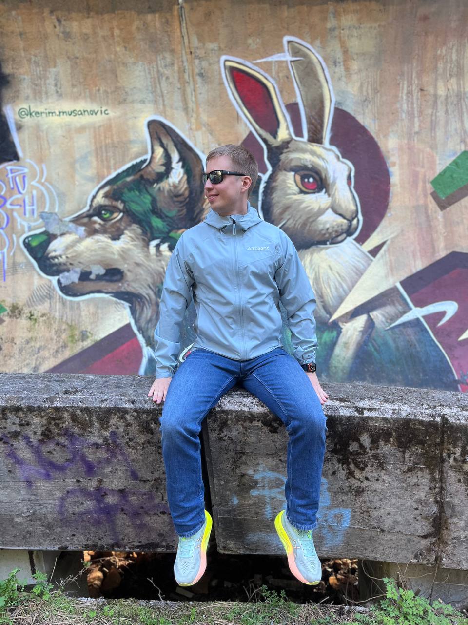 Viktor Shevliagin in front of a street-art mural
